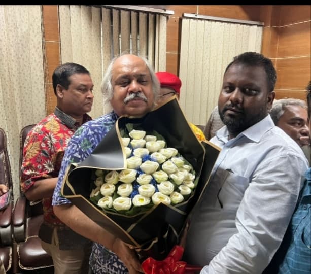 Presenting a bouquet at a felicitation ceremony