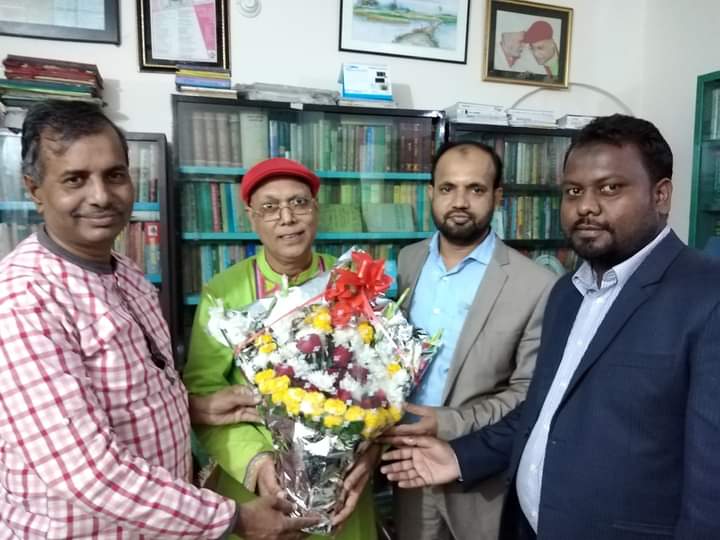 Colleagues presenting flowers in a newsroom office