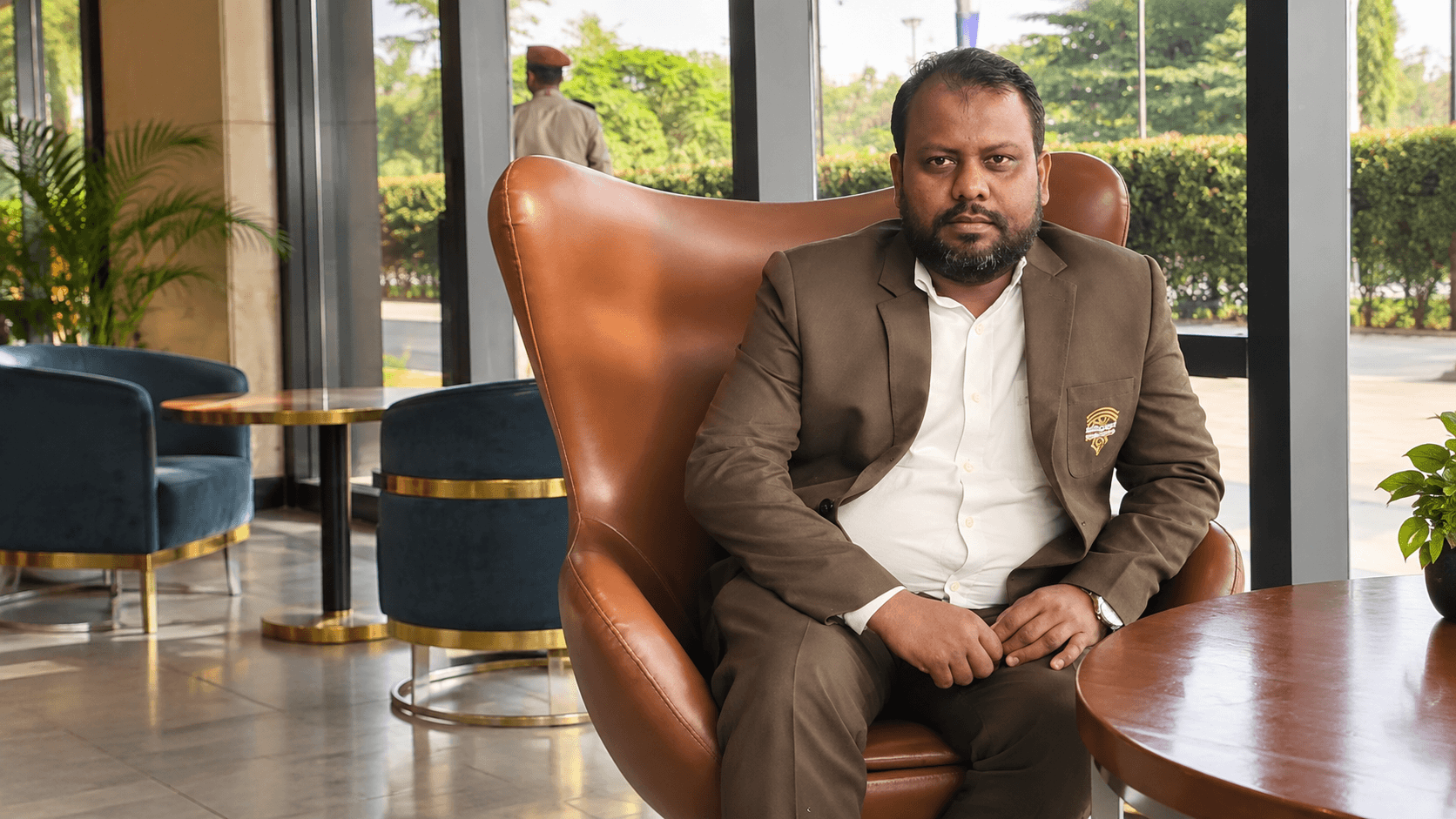 Abdullah Mozomdar, Senior Reporter, seated for a formal portrait